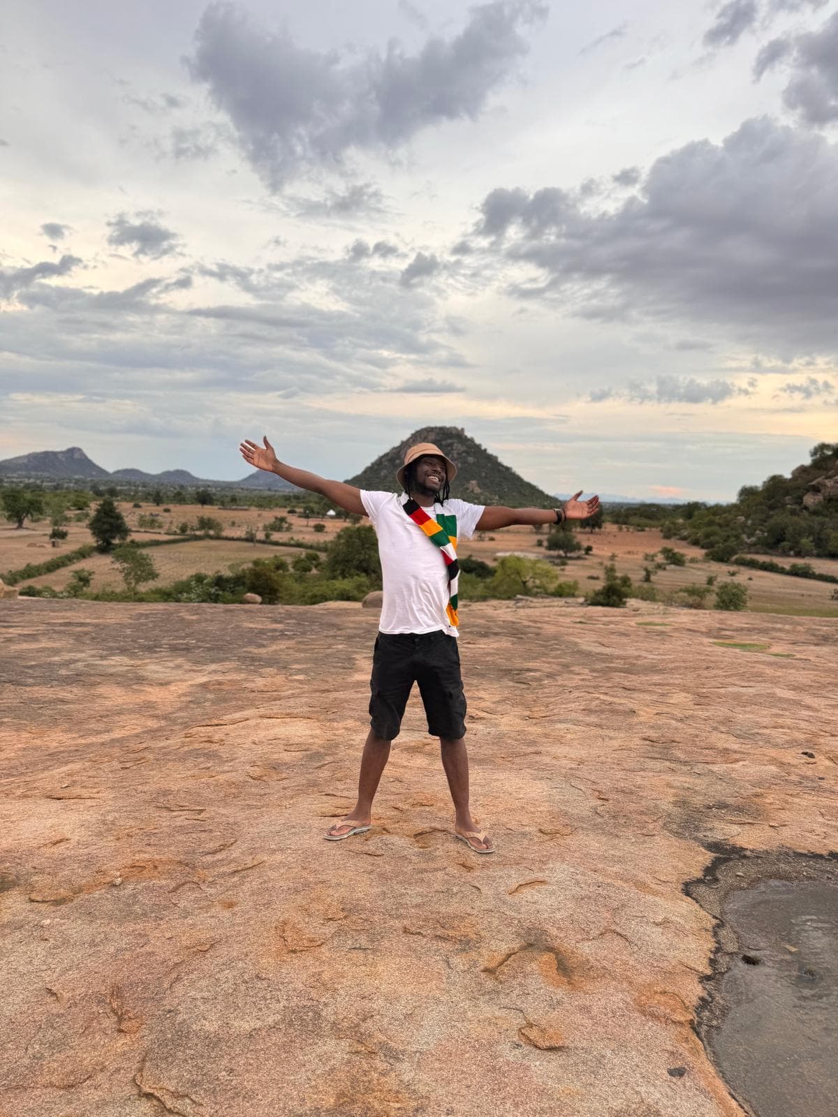 Emperor Roy on a rock in Zimbabwe with arms spread